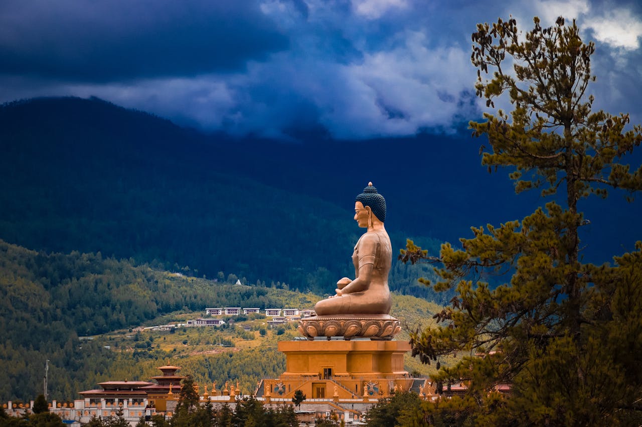 Brown Statue Under Cloudy Sky